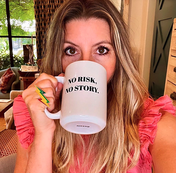 sara blakely sipping from a mug with the quote no risk no story