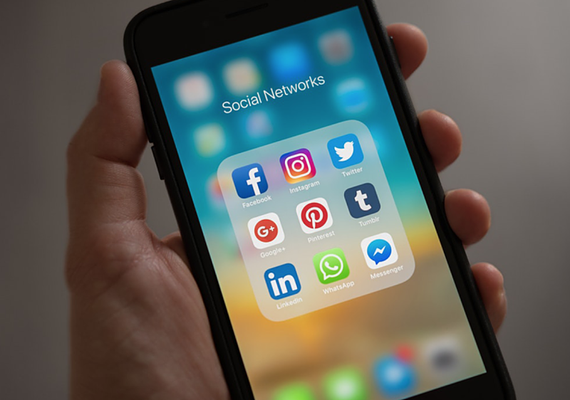 phone displaying social media icons
